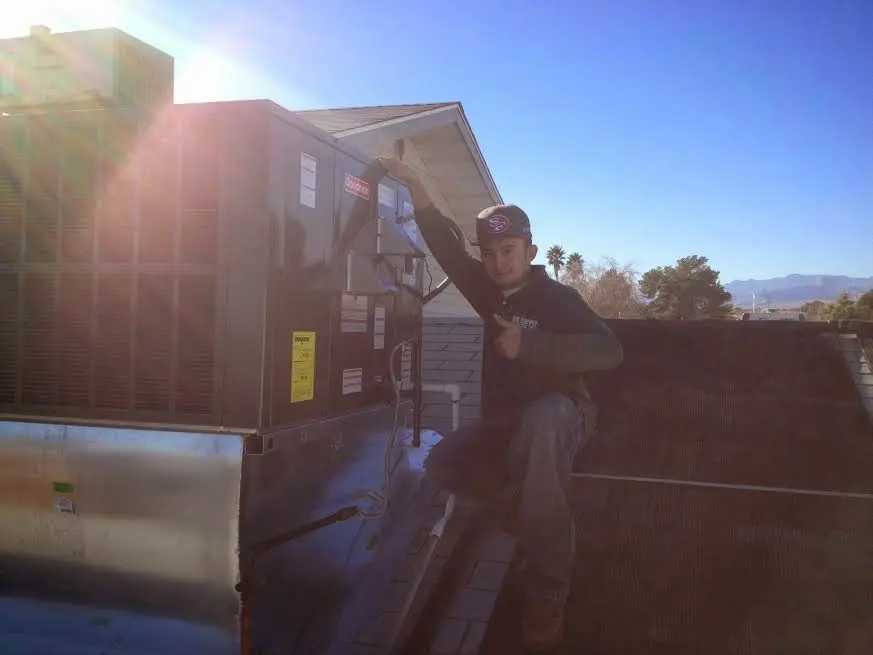 HVAC technician performing Air Duct Cleaning on a rooftop unit in Camarillo